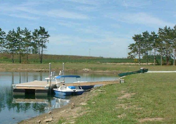 Paddle boats tied up at the dock on the camp lake