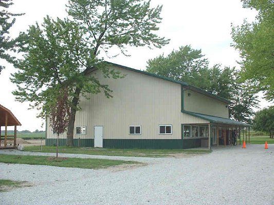 A large camp building beside the trees